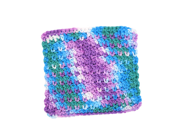 Handmade crocheted cotton dishcloth in blues, purples, greens, and white