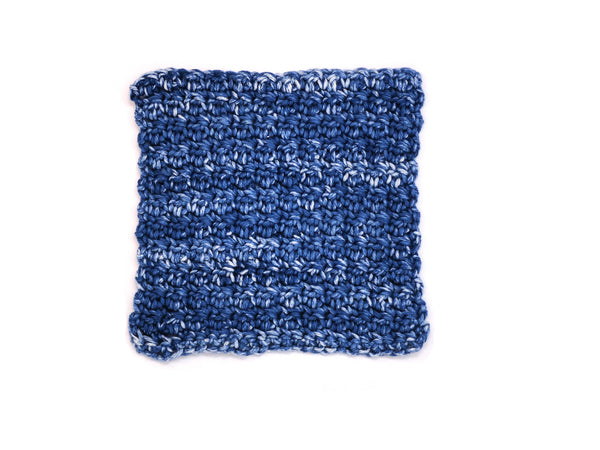 Handmade crocheted wash cloth in faded denim colors